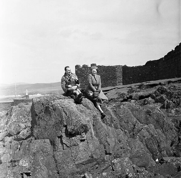 A family enjoys the view in Peel, Isle of Man. May 1954