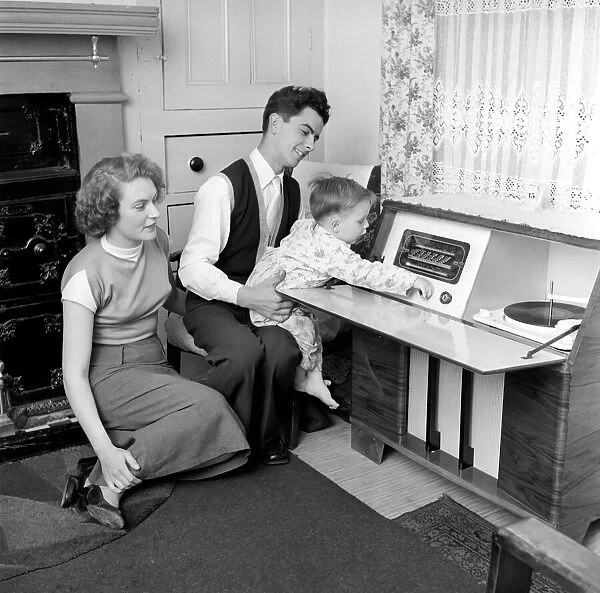 Family Life: Mr. and Mrs. Hull seen here with their son listening to the radio on their