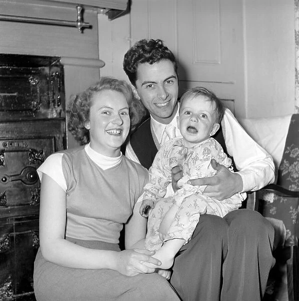 Family life: Mr. and Mrs. Hull with their son before giving him tea. 1954 A160-004