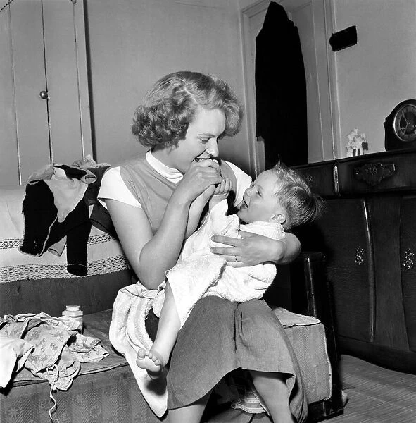 Family life: Mrs. Hull with her son after his bath. 1954 A160-001