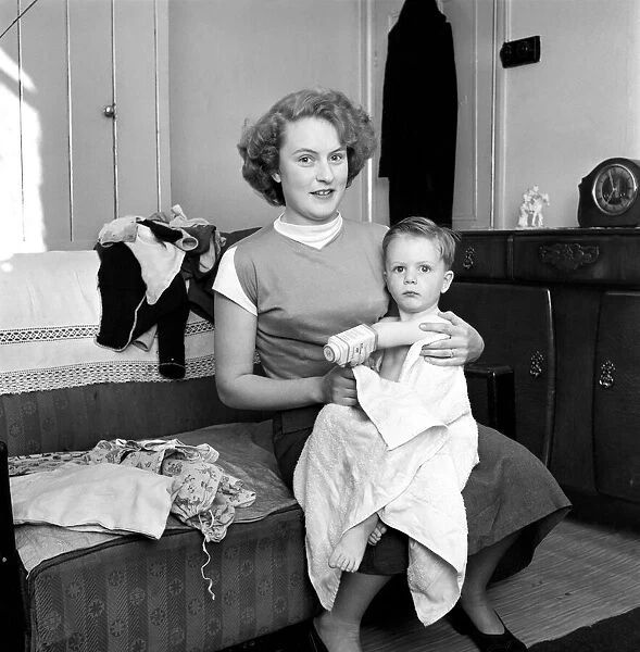 Family life: Mrs. Hull with her son after his bath. 1954 A160
