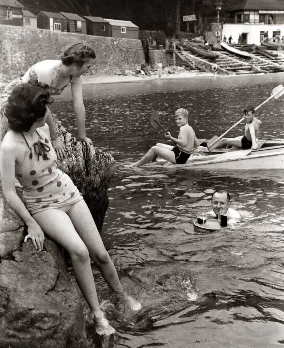 Framed Print : A family sitting on the rocks and playing in the water at Babbacombe Bay in Devon as a Framed Print : A family sitting on the rocks and playing in the water at Babbacombe Bay in Devon as a