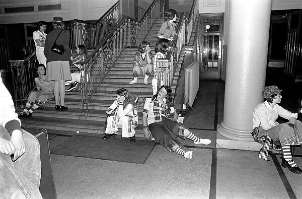 Fans of the Bay City Rollers at their gig in Cardiff take a break on the staircase at