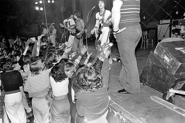 Fans cheer as the Bay City Rollers perform on stage at Cardiff. May 1975