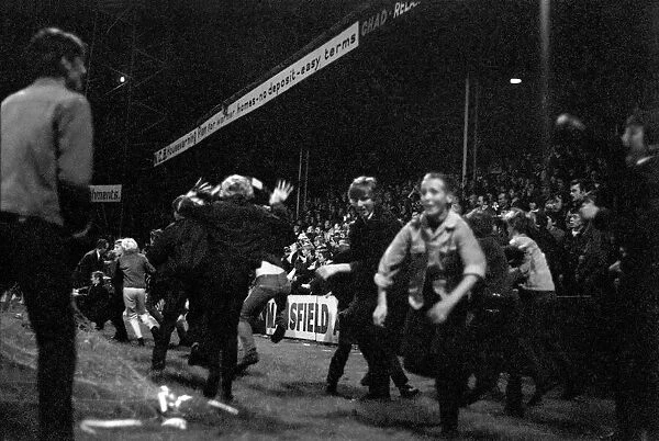 Fans run onto the pitch. Mansfield v. Liverpool. September 1970 71-00193-003