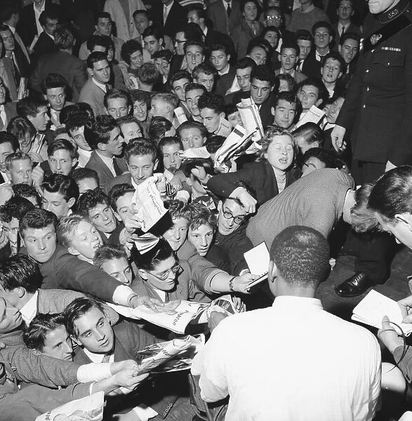 Fans rush forward to get the autograph of jazz legend Lionel Hampton at the Empress Hall