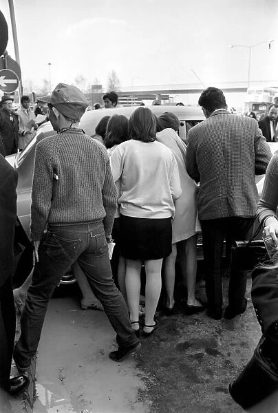 Fans watching the Rolling Stones leaving London Heathrow after arriving from Athens
