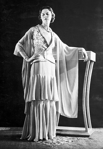 Fashion in the 1930 s: this model is wearing an evening ensemble of opaline green