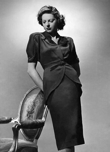 Fashion 1940 s: New style jacket dipping at back, sequin design on shoulders