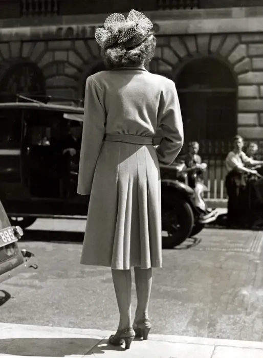 Framed Print : Fashion 1940s Model with her back to the camera wearing a pleated coat with doleen sleves Framed Print : Fashion 1940s Model with her back to the camera wearing a pleated coat with doleen sleves