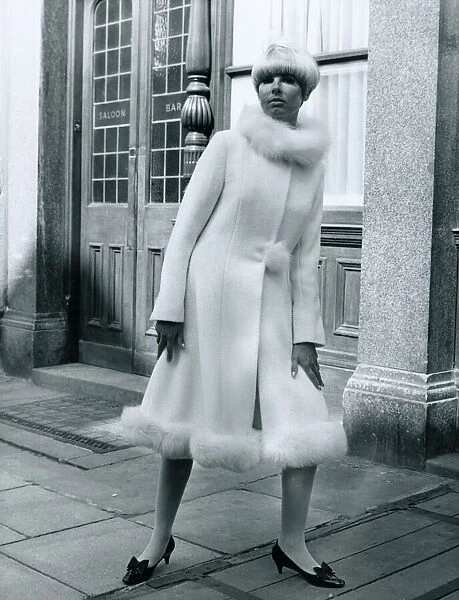 Fashion 1960s Model standing outside Carrot on Wheels boutique wearing a mid-calf