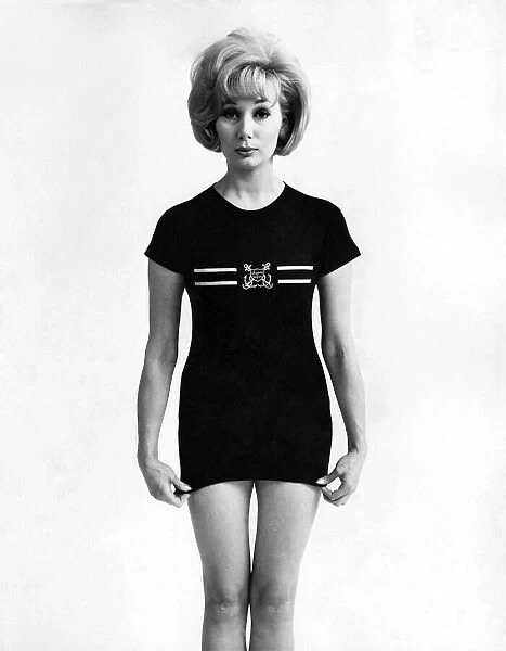 Fashion 1960s. The status symbol shirt. Newest of the status symbols is this T-shirt