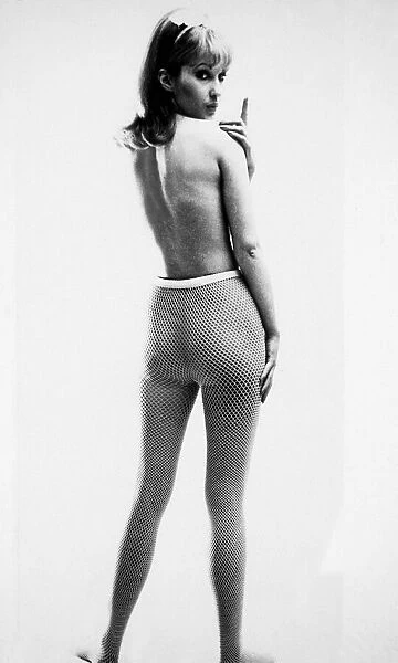 Fashion 1960s Topless model with bare back wearing net type tights