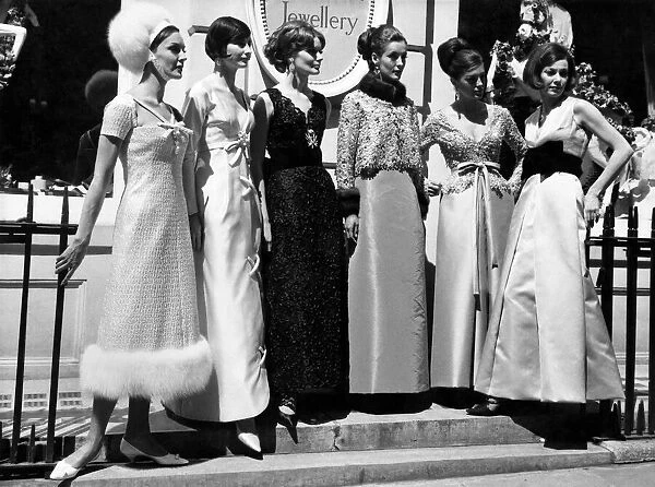 Fashion 1960s. Women gather in a group on the steps in street