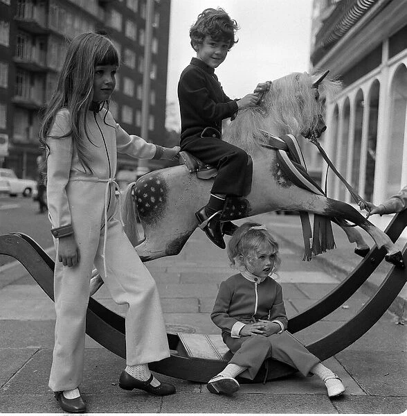 Fashion 1969 Children playing with a rocking horse in West Halkin Street selling