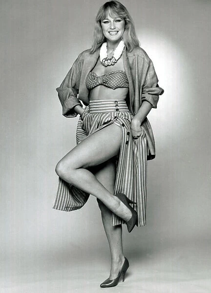 Fashion 1980s Model wearing a striped skirt, silk jacker