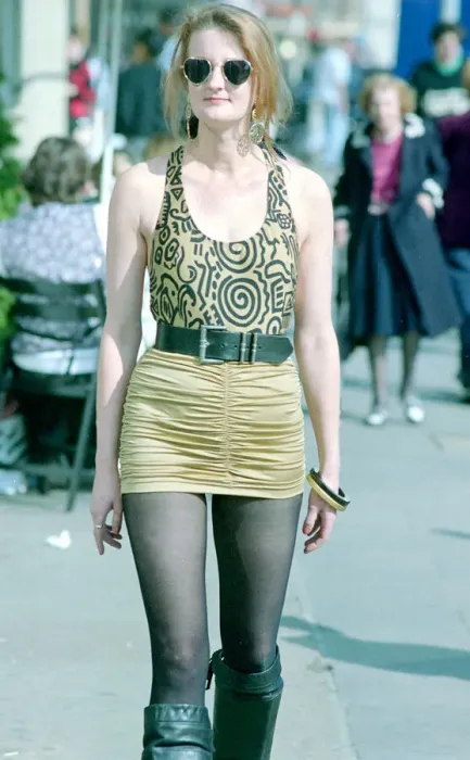 Framed Print : Fashion 1990s Woman walking down the street wearing a mini skirt with a leotard