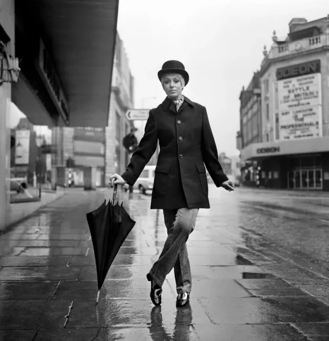 Framed Print : Fashion: Clothing. Unisex clothes. A girl wears a bowler hat, dark overcoat, pin stripes Framed Print : Fashion: Clothing. Unisex clothes. A girl wears a bowler hat, dark overcoat, pin stripes