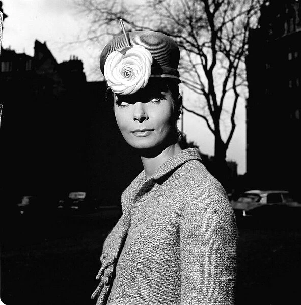Fashion model Mignon Madden models a hat with flower decoration designed by Graham Smith