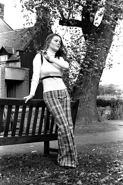 A fashion shoot from 26 October 1971 A model wearing tartan trousers