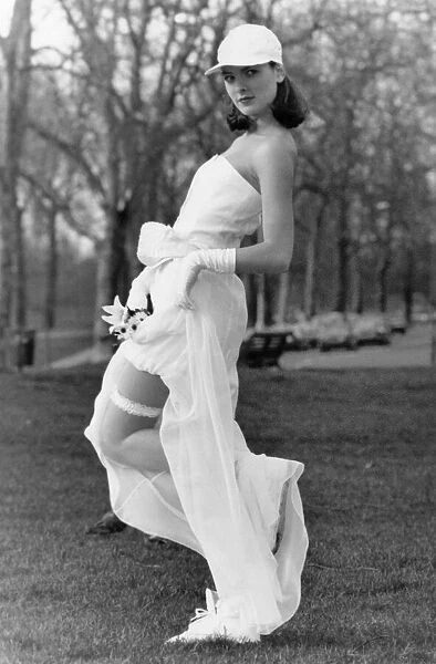 Fashion - Wedding. Model bride flashes her garter. February 1990 P018543