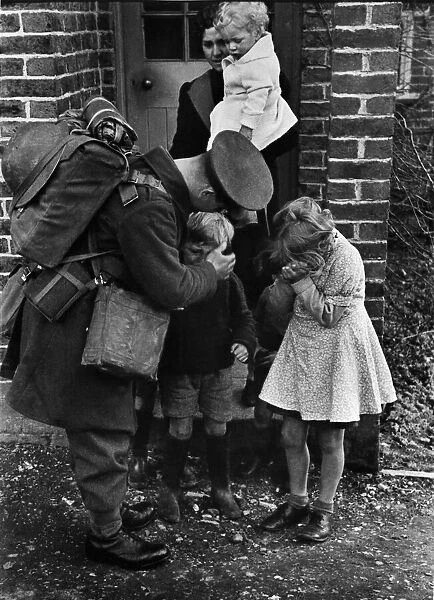 A father called up for war service bids farewell to his children and wife. Circa 1939