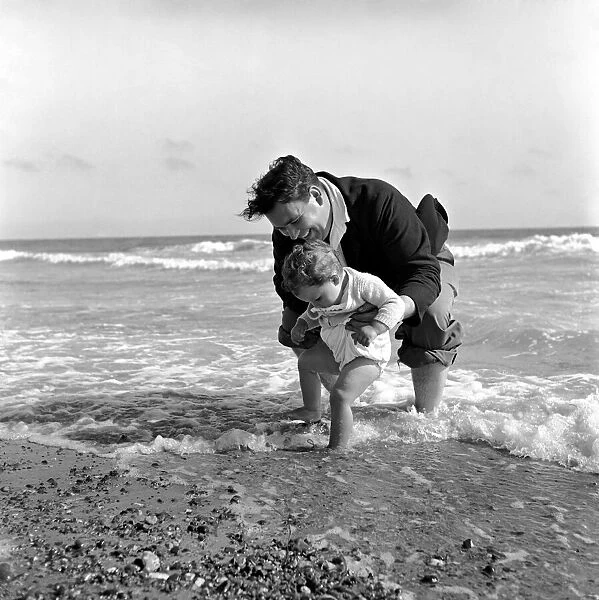 Father and child Padding in the sea at Little Hampton. August 1953 D5204