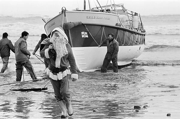 Father Christmas arrives to Newbiggin by lifeboat. Northumberland, December 1985