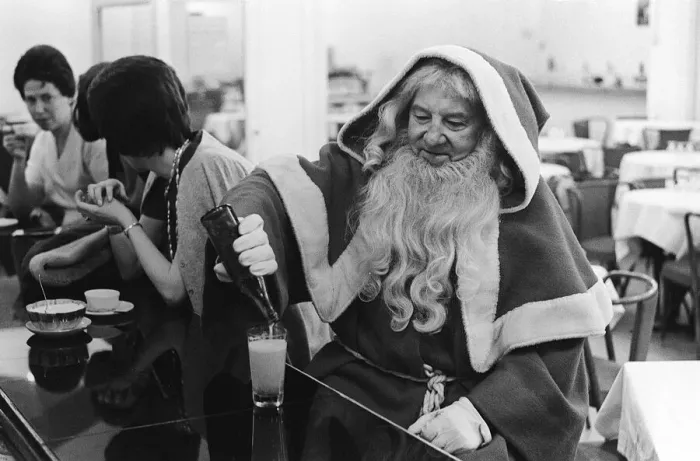 Framed Print : Father Christmas having a drink in a cafe bar in Paris