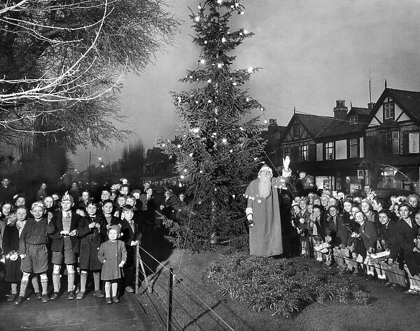 Father Christmas leads school children in carol singing around the Council