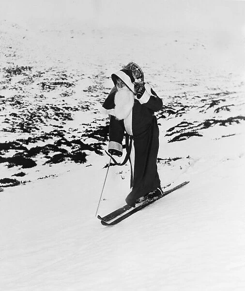 Father Christmas on a pair of skis on the mountain slopes. 31st December 1957