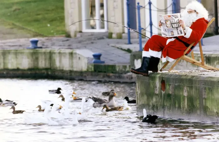 Framed Print : Father Christmas taking a break for the hustle and bustle of Christmas by going fishing