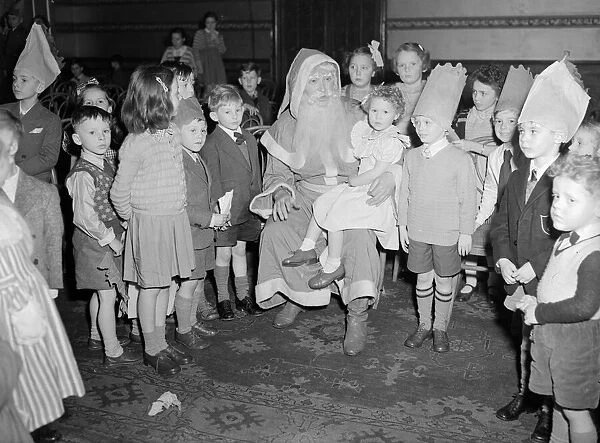 Father Christmas talking too the children at the yearly Daily Mirror Christmas Childrens