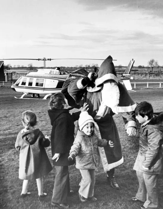 Framed Print : Father Christmas visits a group of very excited children by helicopter, Teesside Framed Print : Father Christmas visits a group of very excited children by helicopter, Teesside