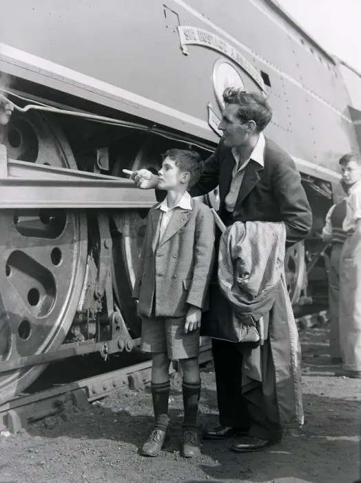 Framed Print : A father and son admire the steam locomotive during an open day at the Ashford railway Framed Print : A father and son admire the steam locomotive during an open day at the Ashford railway