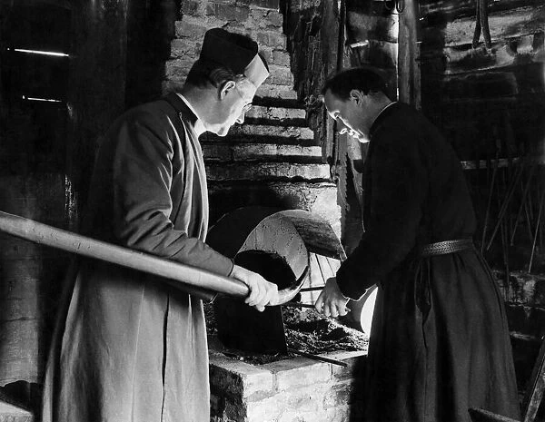 Father Ward and a brother testing the forge which he has re-erected. April 1937 P009950
