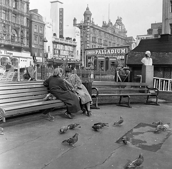 Feeding birds in Leicester Square, London, during lunch hour. 8th March 1954