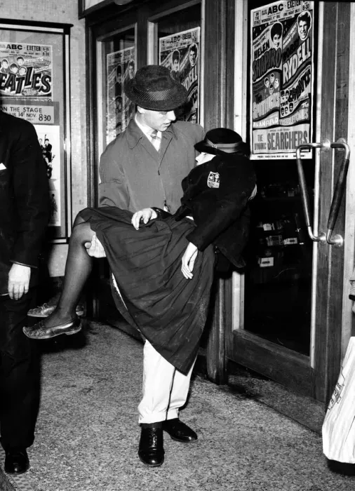 Framed Print : A Female Beatles Fan is carried out at a concert in Exeter. 14th November 1963 Framed Print : A Female Beatles Fan is carried out at a concert in Exeter. 14th November 1963