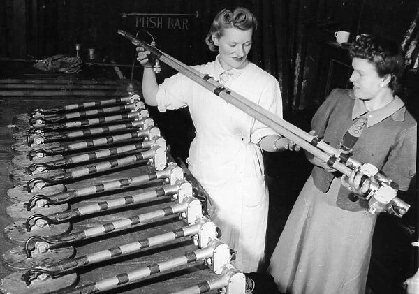 Female factory workers checking land mine detectors. A row of finished detector