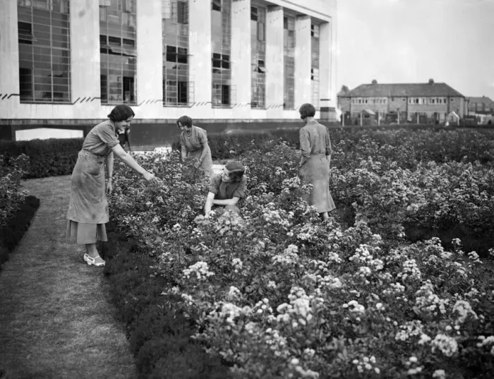 Framed Print : Female Hoover factory workers in a flower garden outside the factory building Framed Print : Female Hoover factory workers in a flower garden outside the factory building
