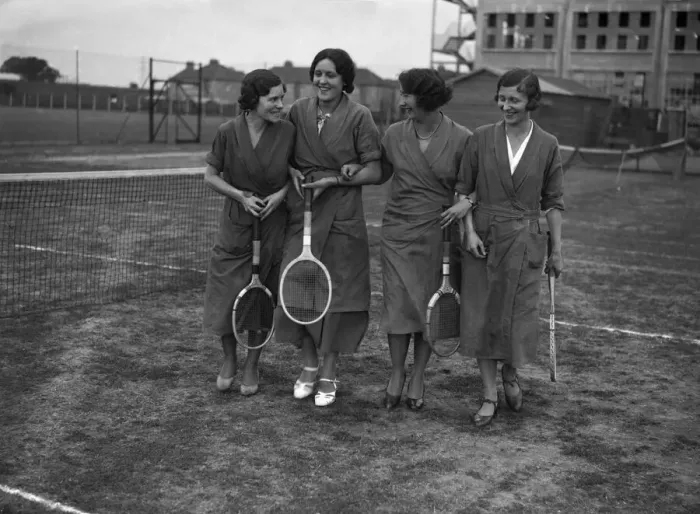 Framed Print : Female Hoover factory workers walking on a tennis court outside the factory building