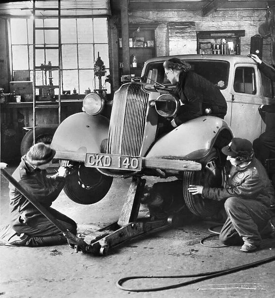 Female mechanics, connected to the ARP (Air Raid Precaution unit) seen fixing a car
