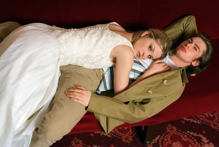 Framed Print : Female model lying on top of a male model along red cinema seats Framed Print : Female model lying on top of a male model along red cinema seats