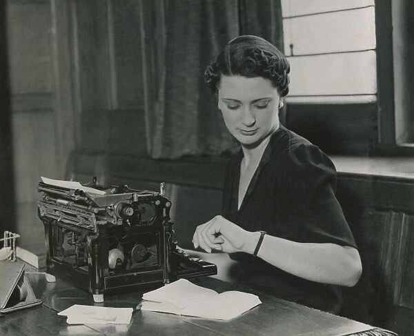 Female office worker checking her watch June 1937