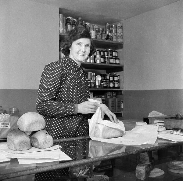 A female worker in a shop in Downe. Which is a village in Greater London within