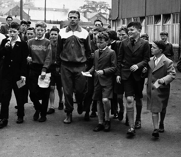 Ferenc Puskas Real Madrid footballer is mobbed by schoolchildren after leaving training