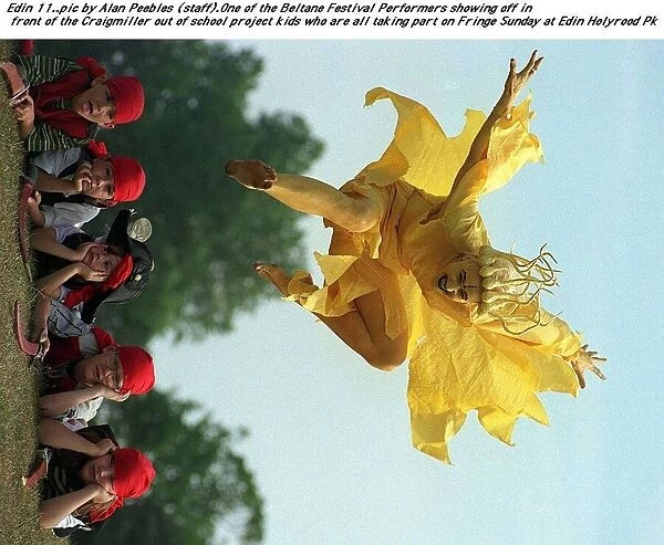 A festival performer dressed as a cruel yellow fairy leaps over the Craigmiller out of