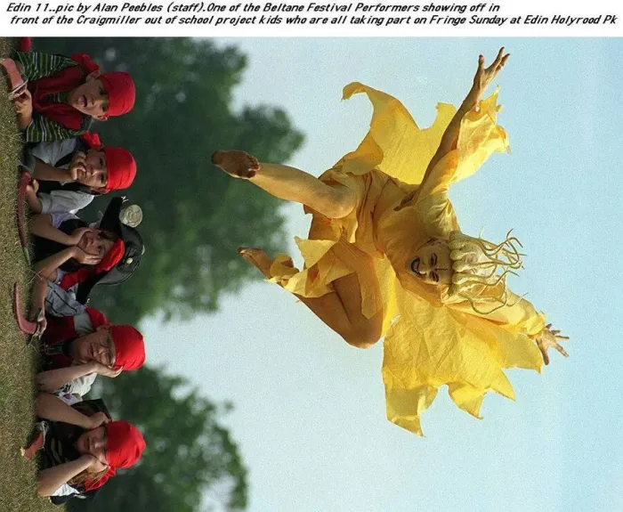 Framed Print : A festival performer dressed as a cruel yellow fairy leaps over the Craigmiller out of Framed Print : A festival performer dressed as a cruel yellow fairy leaps over the Craigmiller out of