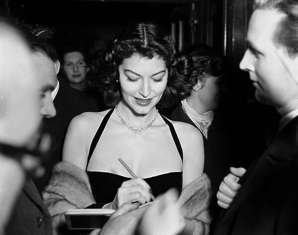 Film actress Ava Gardner signing autographs at a Midnight Matinee at the Colliseum
