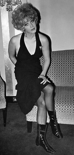 Film actress Linda Thorson wearing a glamourous black dress